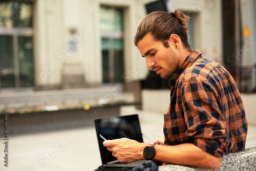 Man shopping online with laptop. Young man buying online with credit card.