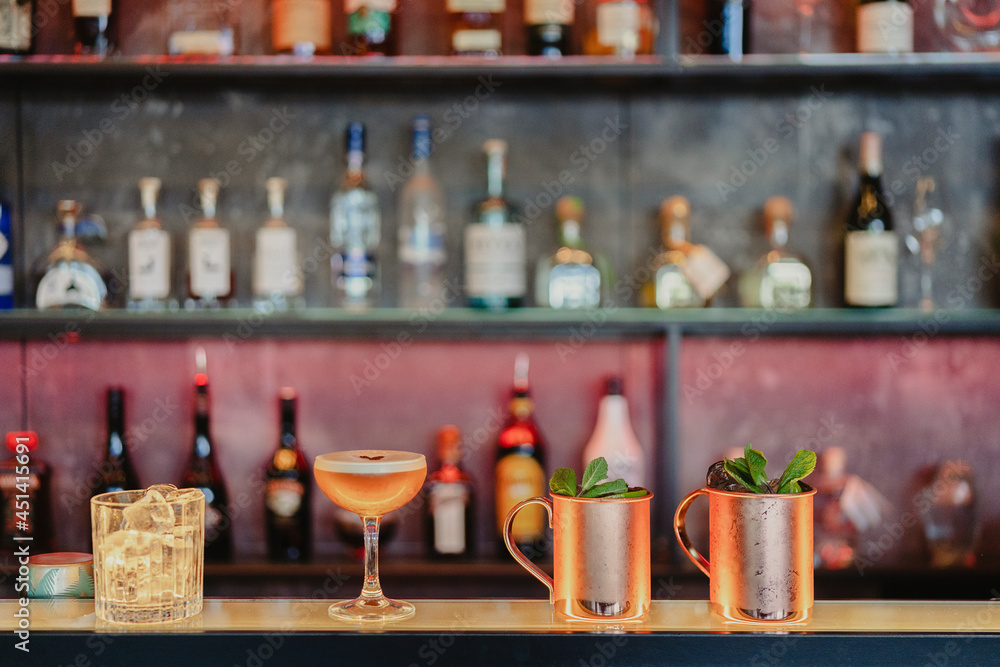 Assorted alcohol cocktails served on counter in bar Assorted alcohol cocktails served on counter in bar