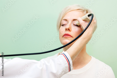 ultrasound examination of the eyes, an ultrasound scanner examines the eyes of a woman. Vision examination concept.