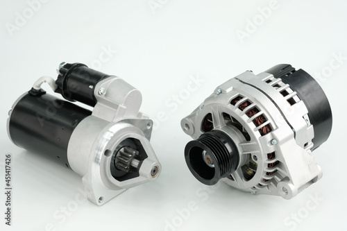 Spare parts for the car engine.New car generator and starter close-up on a white background.