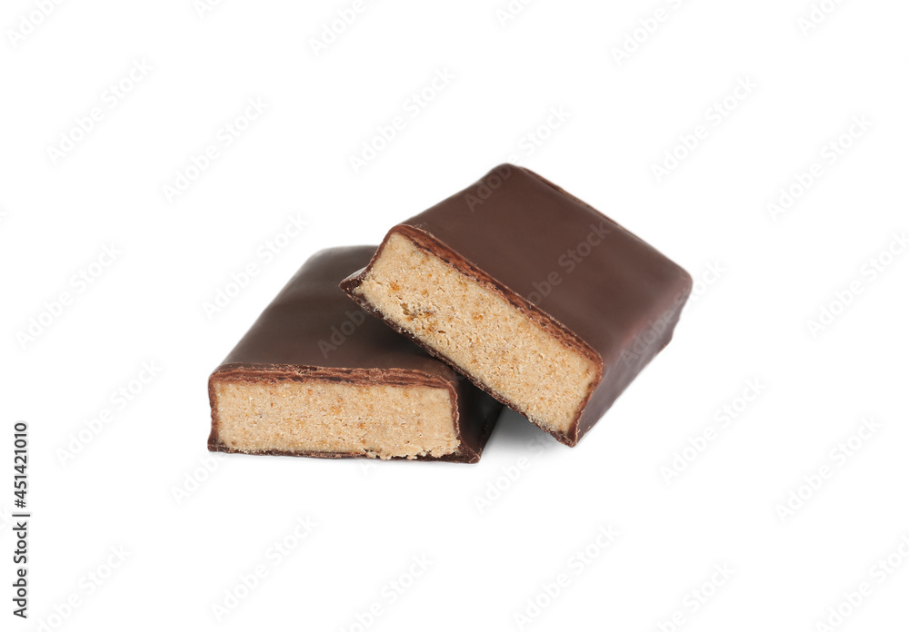 Halves of tasty chocolate glazed protein bar on white background