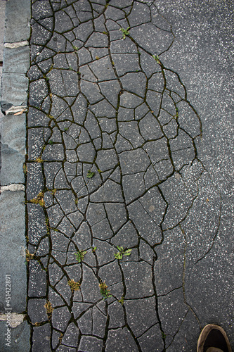 Old cracked asphalt surface. Background or texture. photo