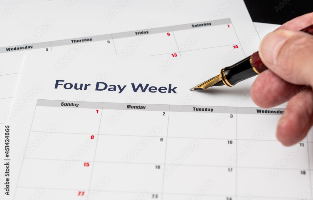 Printed calendar for a 4 day working week showing weekend days in red in new approach to productivity Printed calendar for a 4 day working week showing weekend days in red in new approach to productivity