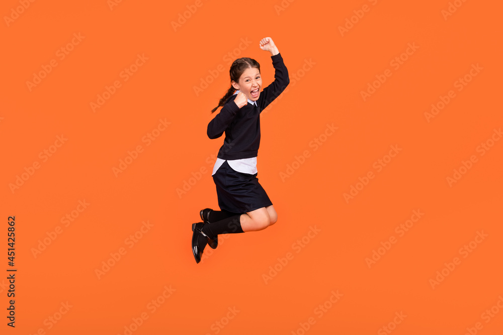 Full body photo of brunette braids haired girl jump up wear long socks winner isolated on orange color background