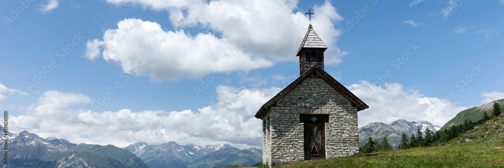 Panoramic view of the mountains. Small chapel on the mountain with a view of the Grossglockner in Austria Panoramic view of the mountains. Small chapel on the mountain with a view of the Grossglockner in Austria