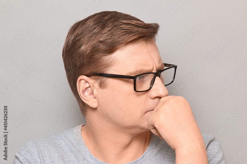 Portrait of serious thoughtful blond mature man with glasses Portrait of serious thoughtful blond mature man with glasses
