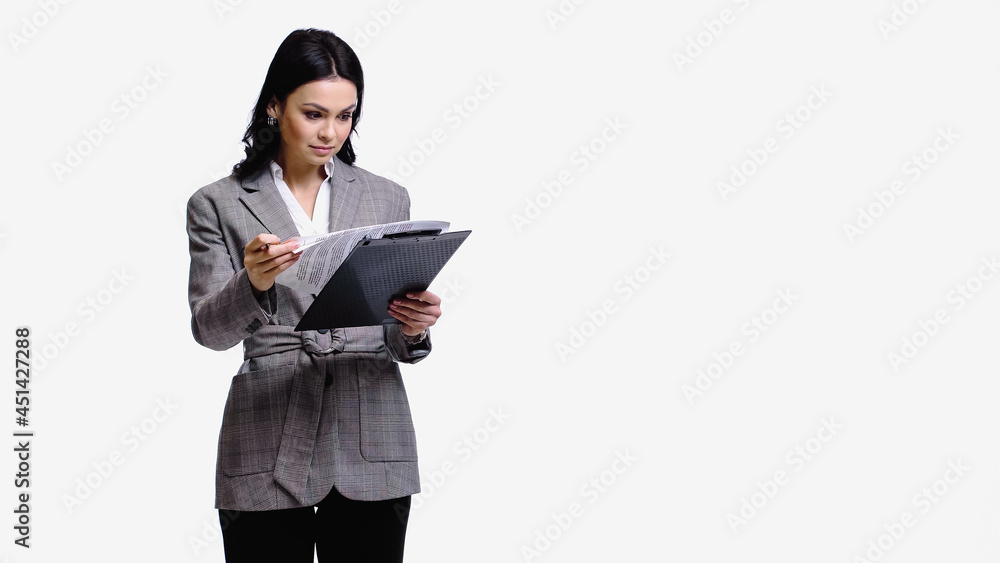 Businesswoman looking at papers on clipboard isolated on white. Businesswoman looking at papers on clipboard isolated on white.