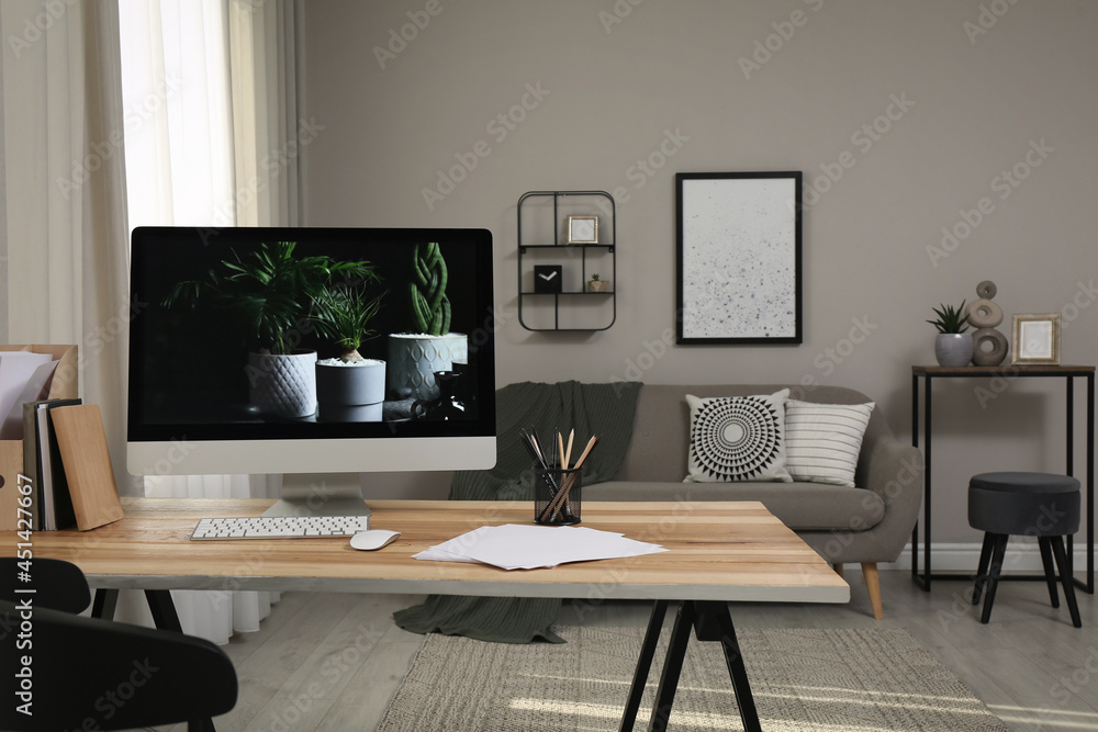 Comfortable workplace with computer on wooden desk in modern office. Interior design Comfortable workplace with computer on wooden desk in modern office. Interior design
