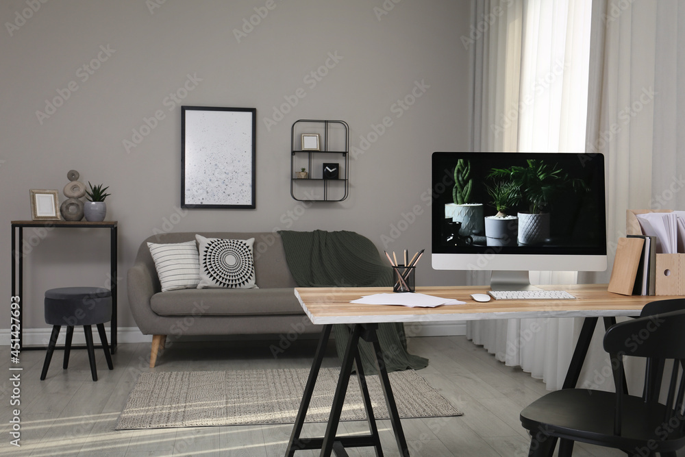 Comfortable workplace with computer on wooden desk in modern office. Interior design Comfortable workplace with computer on wooden desk in modern office. Interior design