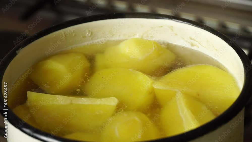 Golden potatoes cooked in hot water in a saucepan. The process of cooking the perfect boiled potatoes in boiling water. Golden potatoes cooked in hot water in a saucepan. The process of cooking the perfect boiled potatoes in boiling water.