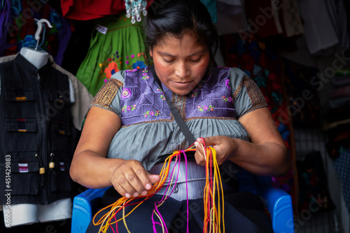 Mexican craftswoman weaving by hand to sell hers products