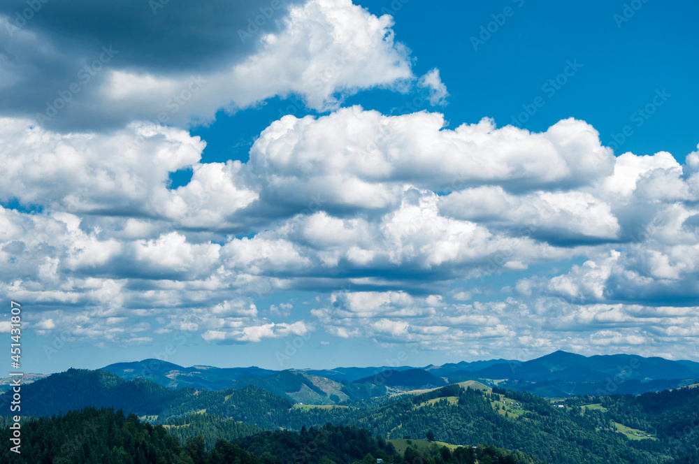 beautiful cloudy blue sky over green summer mountains, morning landscape. High quality photo