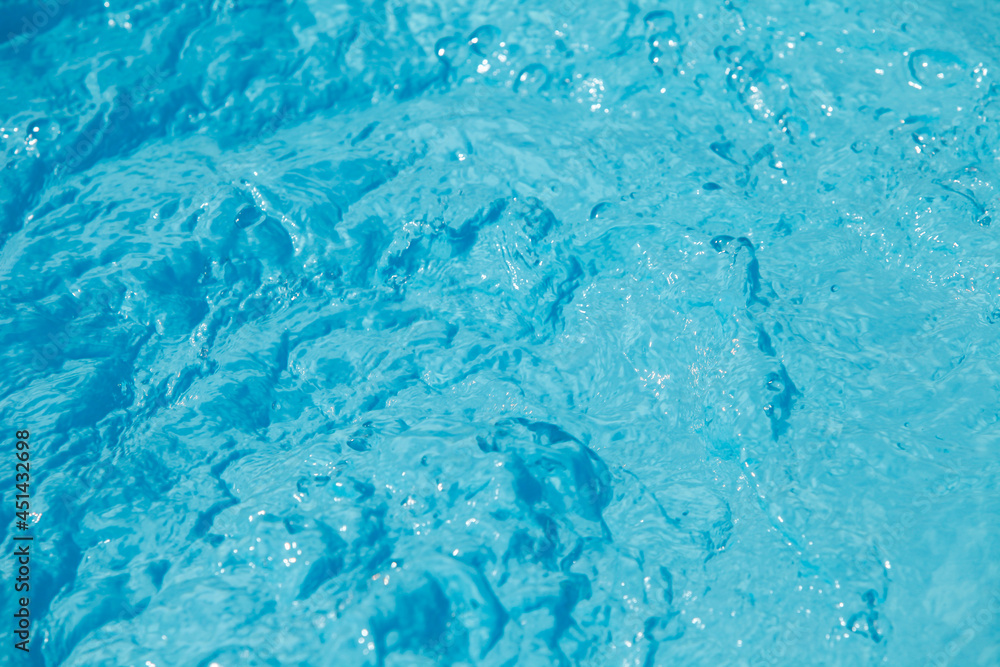 Water and air bubbles over blue background,sea wave ,Bokeh light background in the pool,Hotel swimming pool with sunny reflections. Water and air bubbles over blue background,sea wave ,Bokeh light background in the pool,Hotel swimming pool with sunny reflections.