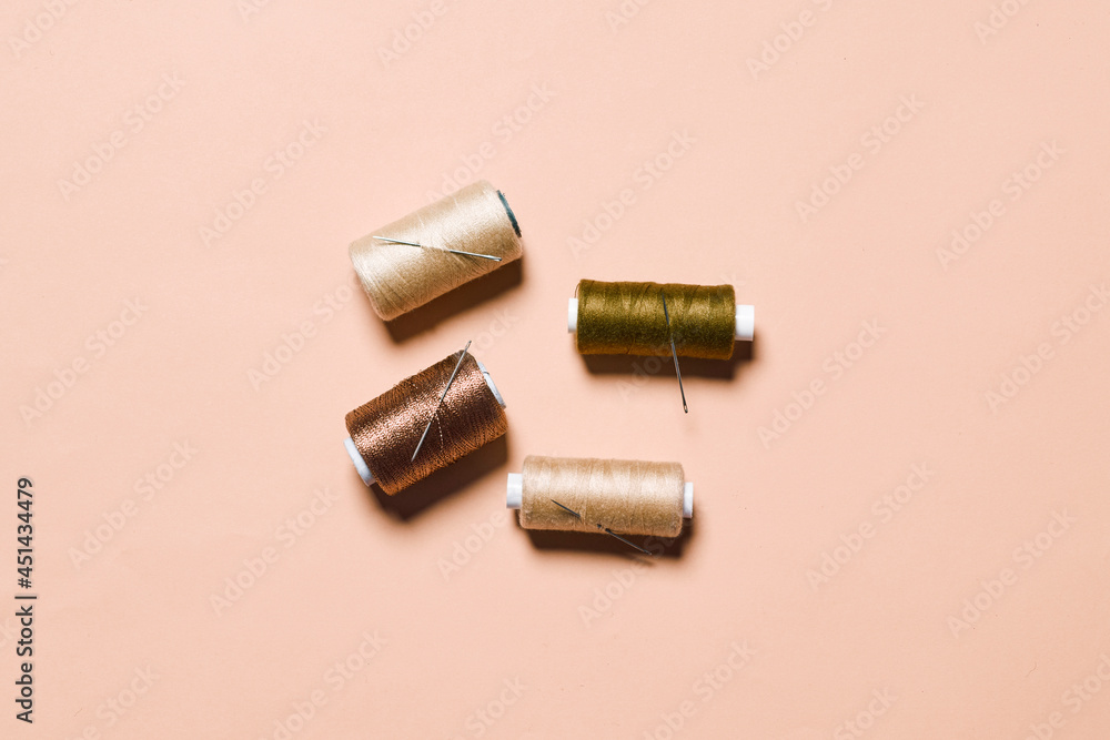 Sewing items flat lays from above. Collection of threads for sewing on bright background Sewing items flat lays from above. Collection of threads for sewing on bright background