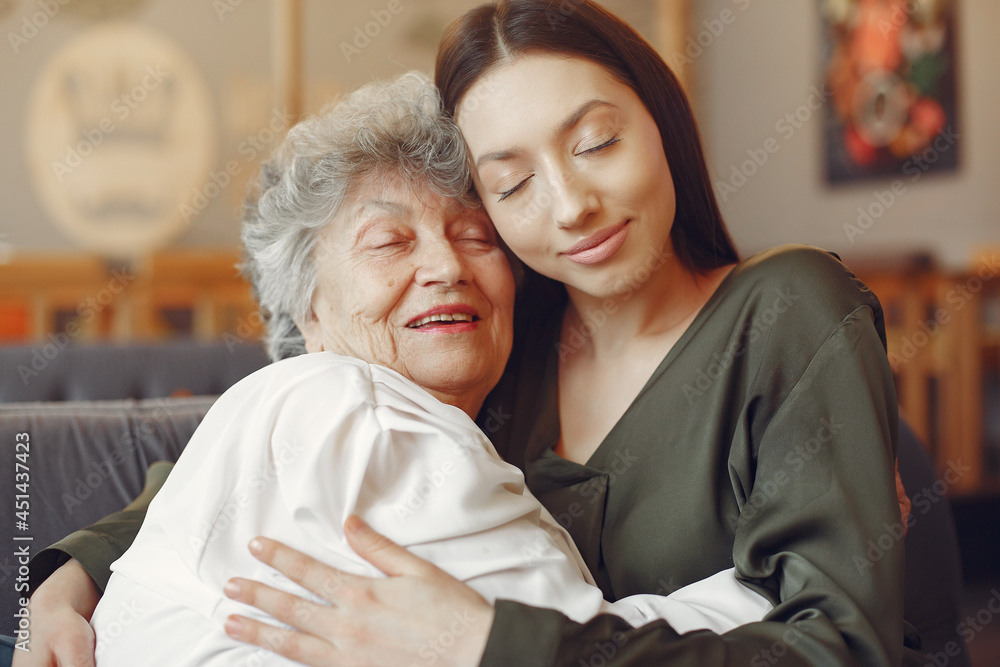 Old woman in a cafe with young granddaughter Old woman in a cafe with young granddaughter