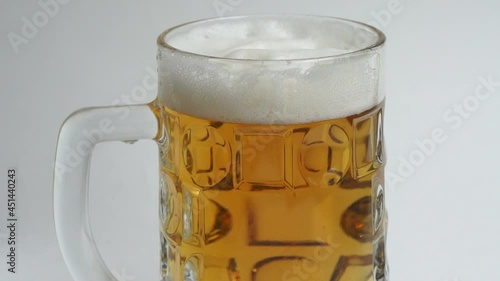 Beer with foam in a glass mug 