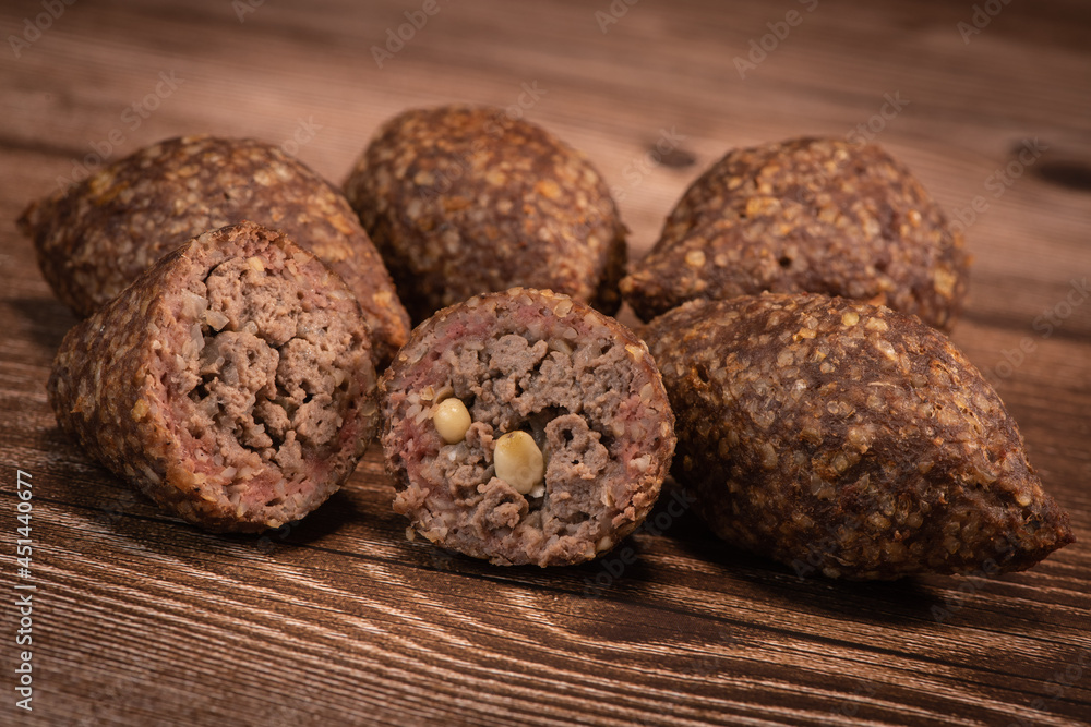 Traditional kebbe and pita bread on big round plate in lebanese restaurant. High quality photo Traditional kebbe and pita bread on big round plate in lebanese restaurant. High quality photo