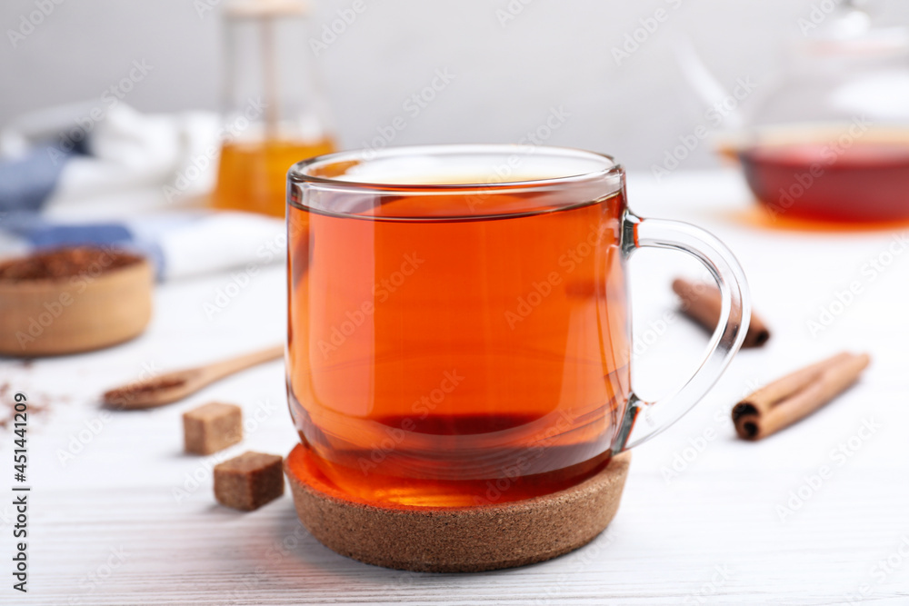 Freshly brewed rooibos tea on white wooden table Freshly brewed rooibos tea on white wooden table