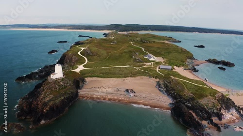 Aerial view of Twr Mawr lighthouse meaning great tower in Welsh on Ynys Llanddwyn on Anglesey Wales marks the western entrance to the Menai Strait.