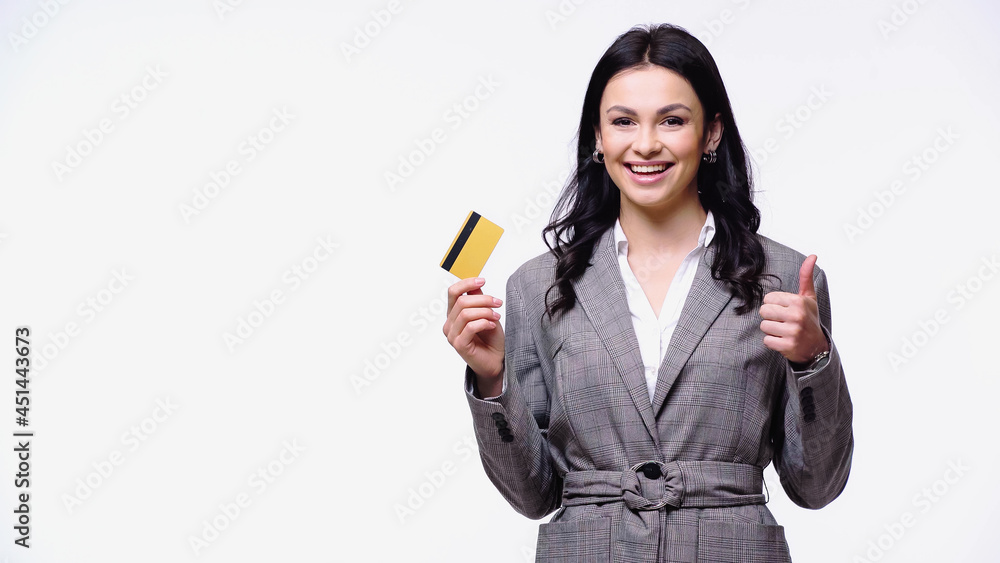 Positive manager holding credit card and showing thumb up isolated on white. Positive manager holding credit card and showing thumb up isolated on white.