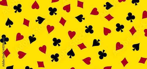 Playing card suit pattern on yellow background, casino or poker games concept.