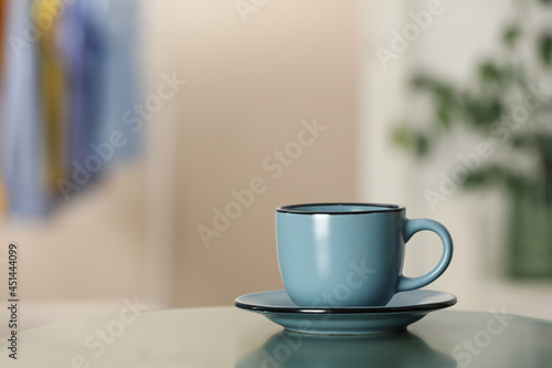 Ceramic cup on table in room  space for text