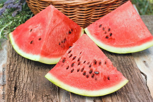Sweet, jucy watermelon, sliced of watermelon on rustic table