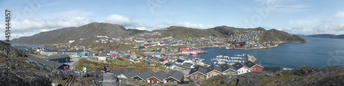 View from one of the many hills of Qaqortog, Iceland, towards the colorful houses of the city, on the left the inland lake Tasersuaq, on the right the fjord