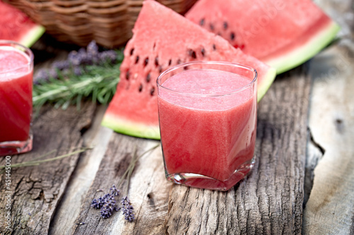 Watermelon smoothie and slices of watermalon on table