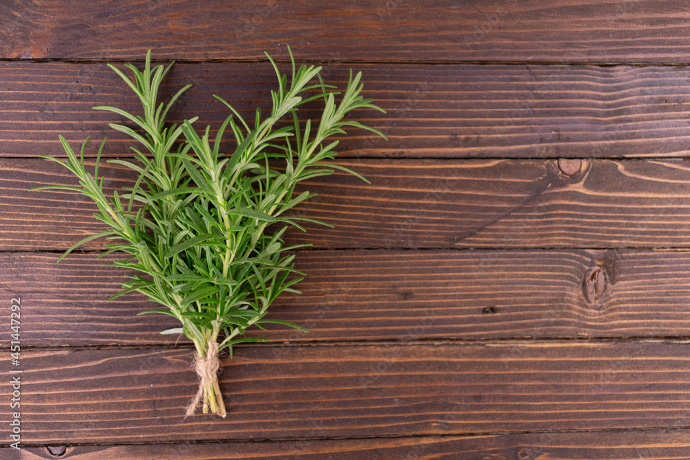 Fresh rosemary on a wooden background. Copy space. Fresh rosemary on a wooden background. Copy space.