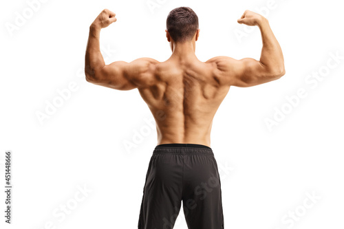 Rear view of a bodybuilder shirtless flexing muscles
