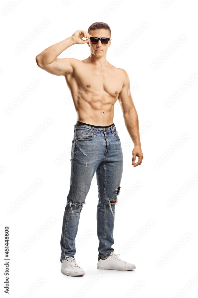 Full length portrait of a shirtless young man wearing jeans and sunglasses Full length portrait of a shirtless young man wearing jeans and sunglasses