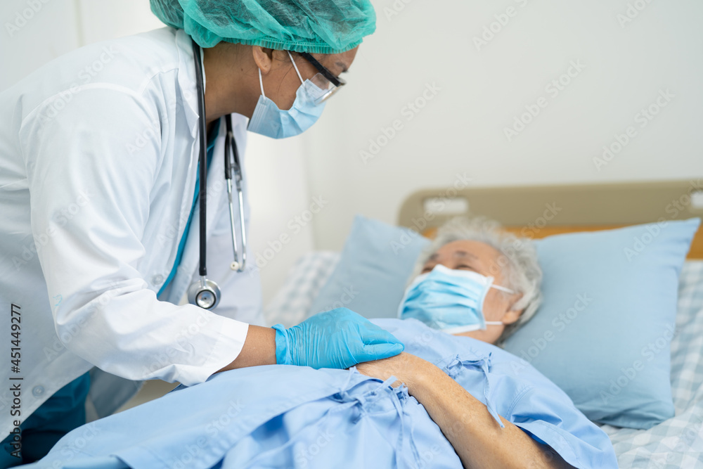 Doctor help Asian senior or elderly old lady woman patient wearing a face mask in hospital for protect safety infection and kill Covid-19 Coronavirus. Doctor help Asian senior or elderly old lady woman patient wearing a face mask in hospital for protect safety infection and kill Covid-19 Coronavirus.