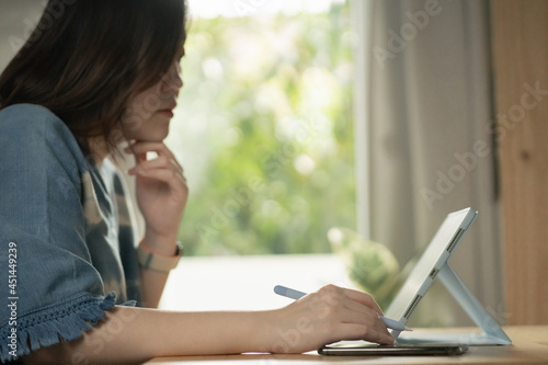 asian woman use tablet meeting and working from home