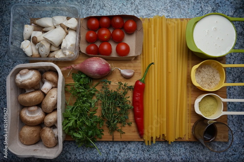 Ingredients for a vegan fettuccine in cream sauce with king oyster mushrooms, lemon thyme and roasted cherry tomatoes