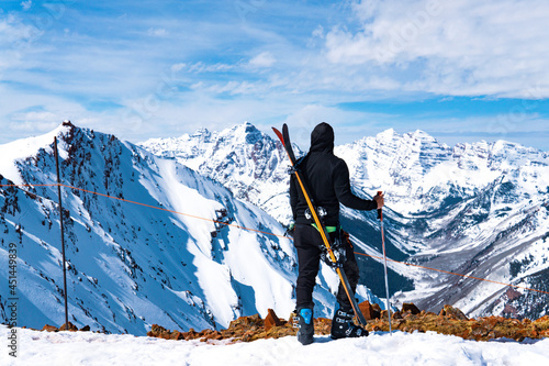 Man With Skis At Summit Extreme Ski Concept photo