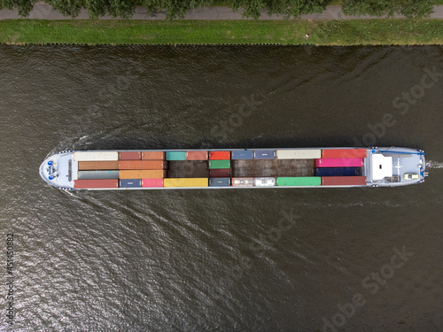 Container cargo ship at Amsterdams Rijn Canal in the Netherlands, topdown birdsseye view