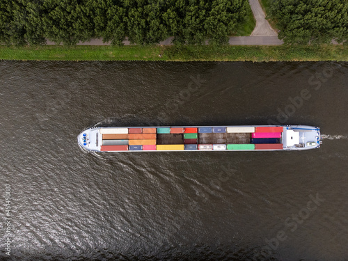Obraz na płótnie Container cargo ship at Amsterdams Rijn Canal in the Netherlands, topdown birdss