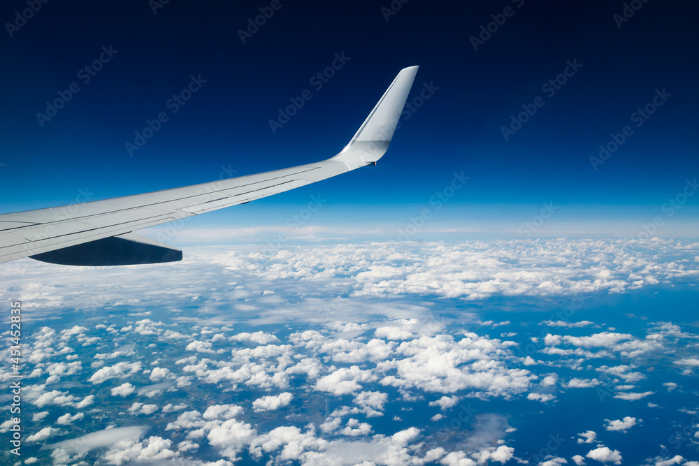 Plain wing over blue sky. Flight from Helsinki to Amsterdam.