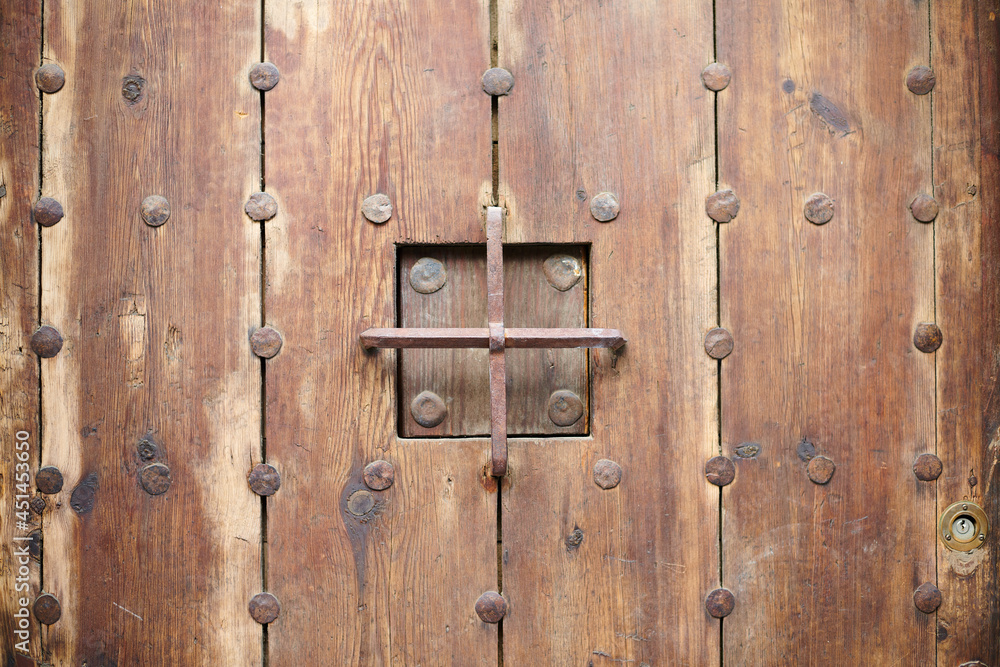 Old, aged, traditonal wooden carved doors in Seville