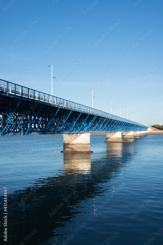 Beautiful old blue bridge over Arade river at Portimao. Sunset, no people, Portugal. Europe