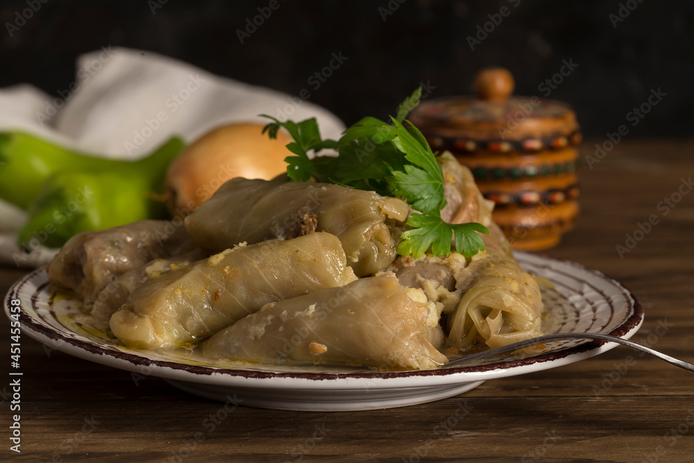Cabbage rolls in a plate on a wooden table