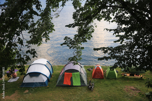 camping tents in front of the lake