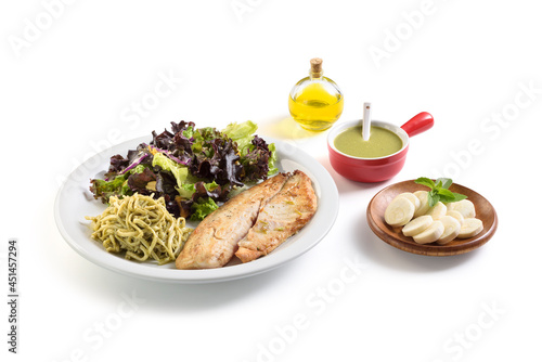 Front view of delicious chicken, pasta and salad meal, with condiments aside, isolated