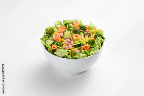 Fresh salmon, cucumber and broccoli salad, in white bowl, isolated