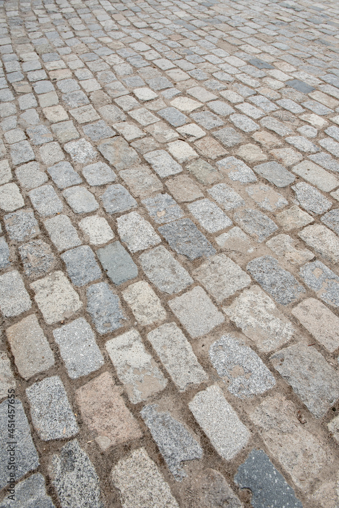 Cobblestones paving the floor of a street.