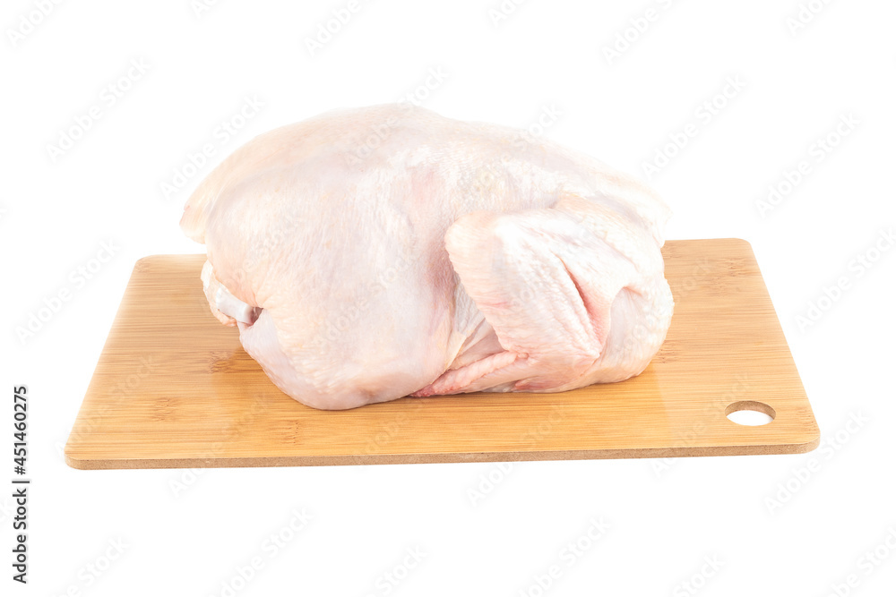 Whole fresh chicken on a cutting board over a white background.