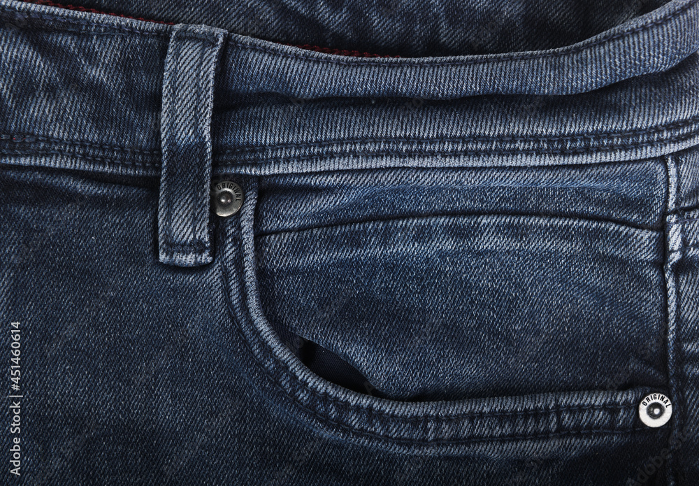 Close-up of dark blue jeans pockets.
