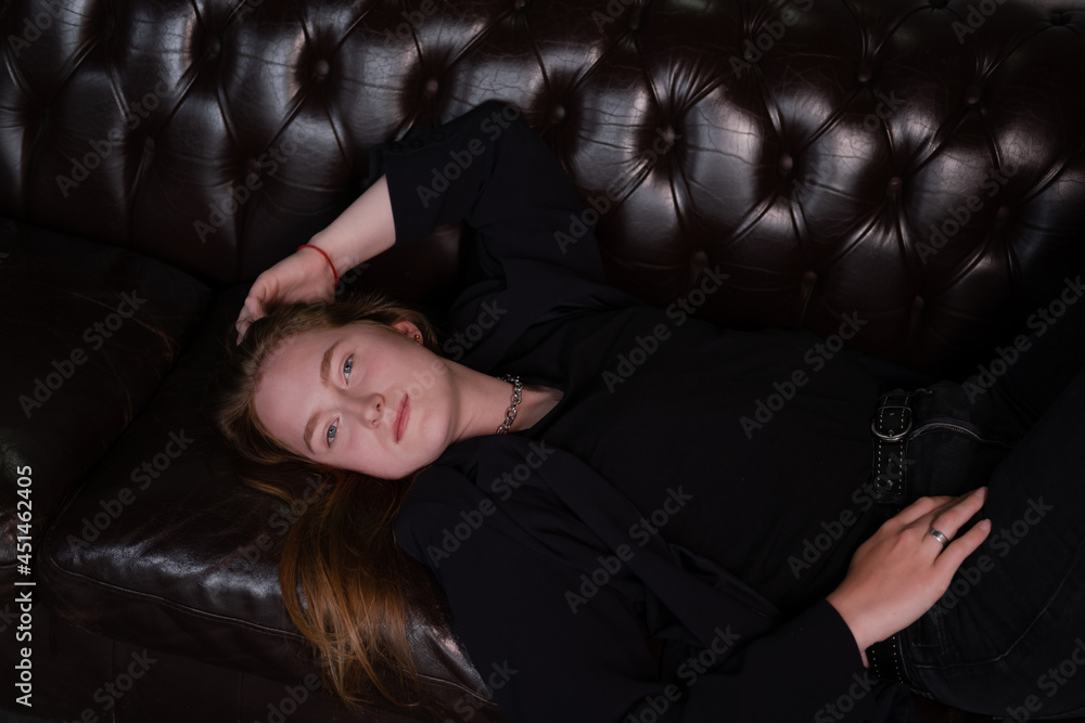 portrait of beautiful confident brunette woman in black in grey dark room. business woman. feminine. millennial people. stylish fashion clothes portrait of beautiful confident brunette woman in black in grey dark room. business woman. feminine. millennial people. stylish fashion clothes