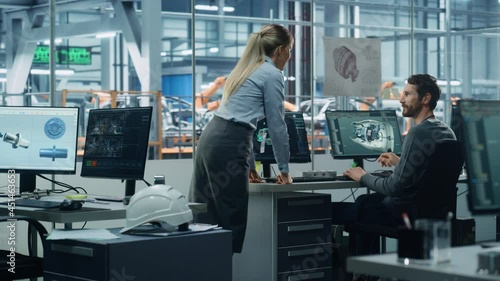 Wallpaper Mural Car Factory Office: Project Manager Talks to Engineer Working on Computer, uses CAD Software with 3D Green Energy Turbine Engine, Electric Car. Automated Robot Arm Assembly Line Manufacturing Vehicles Torontodigital.ca